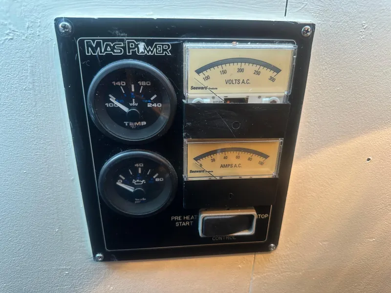 Slide: The Image of Control panel of a 1974 Bertram 42 Motor Yacht with gauges and switches. - 35
