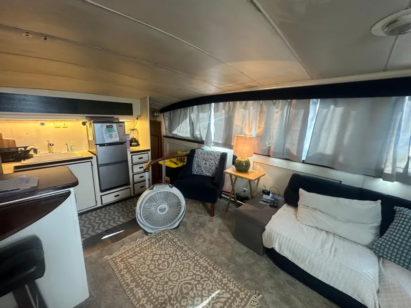 Slide: The Image of Interior of a 1974 Bertram 42 Motor Yacht with cozy seating and kitchen area. - 41