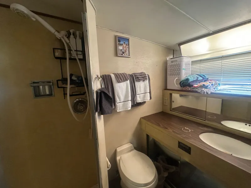 Slide: The Image of 1974 Bertram 42 Motor Yacht bathroom with shower, sink, and towels. - 48