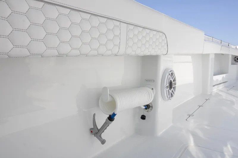 Slide: The Image of 2026 Invincible 36 Catamaran interior with open storage compartment and sleek design. - 10