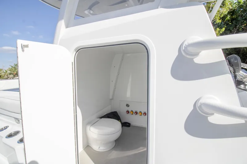 Slide: The Image of 2026 Invincible 36 Catamaran interior with sleek white design and hexagonal upholstery. - 11
