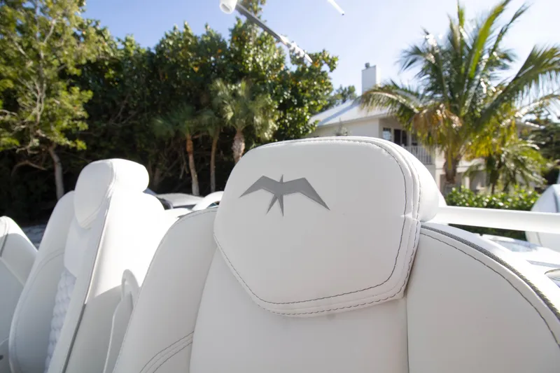 Slide: The Image of 2026 Invincible 36 Catamaran with luxurious seating and powerful engines, surrounded by palm trees. - 22