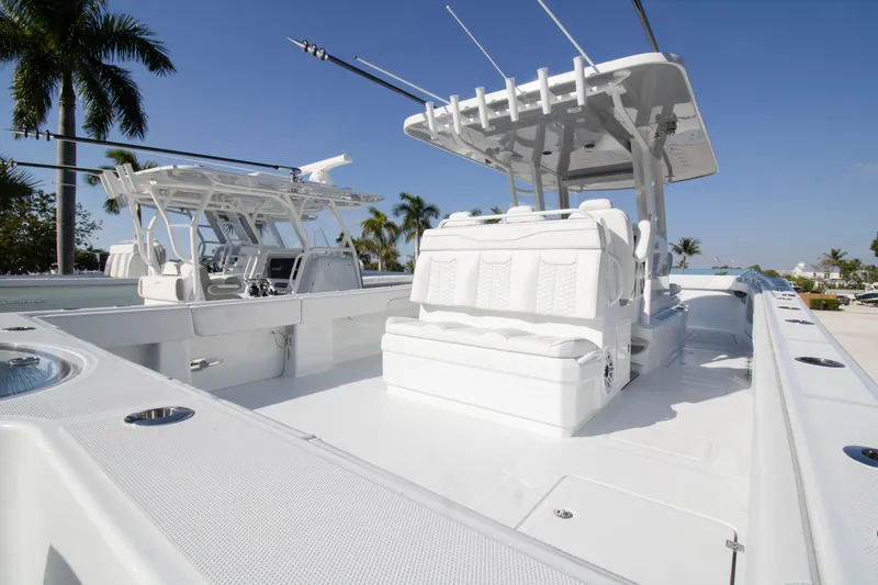Slide: The Image of Luxurious seating on 2026 Invincible 36 Catamaran, surrounded by palm trees. - 23