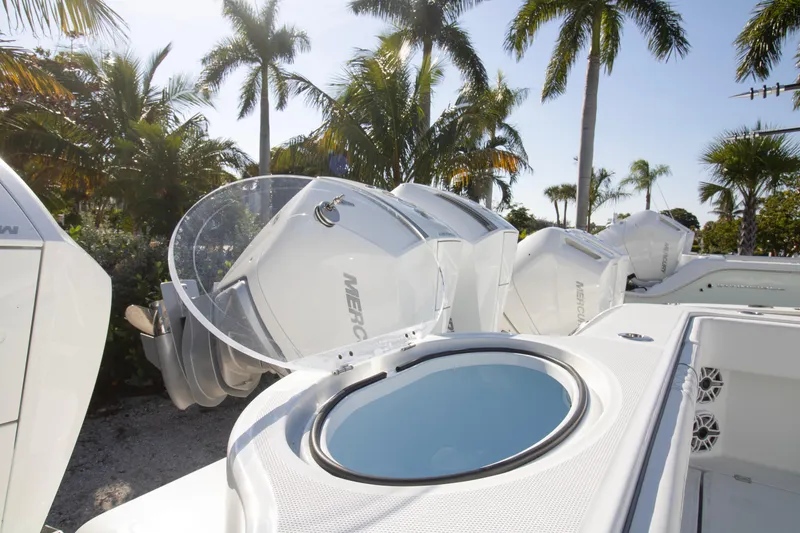 Slide: The Image of 2026 Invincible 36 Catamaran with four Mercury outboard engines, tropical backdrop. - 28