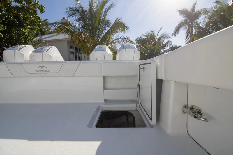 Slide: The Image of 2026 Invincible 36 Catamaran with Mercury engines, sleek design, and palm trees in the background. - 29