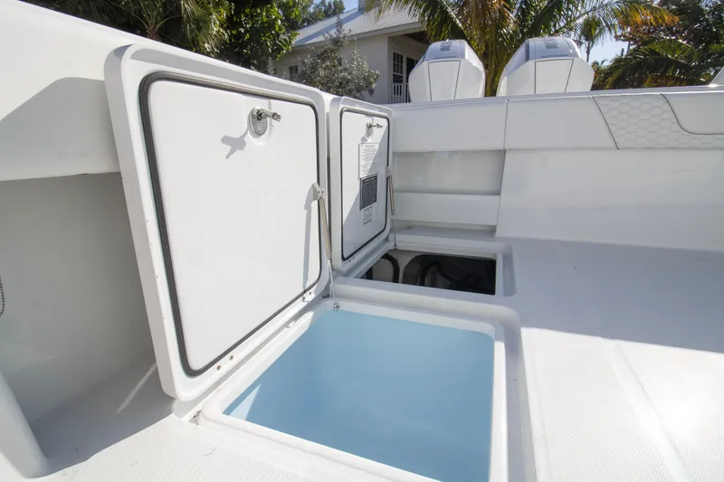 Slide: The Image of 2026 Invincible 36 Catamaran with powerful Mercury outboard engines, surrounded by palm trees. - 30