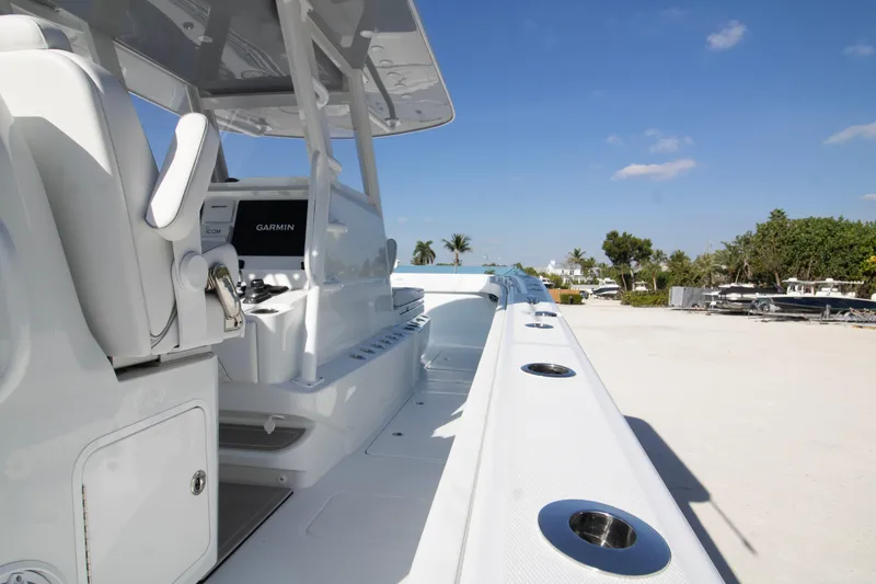 Slide: The Image of 2026 Invincible 36 Catamaran interior with sleek white design and palm trees in background. - 33