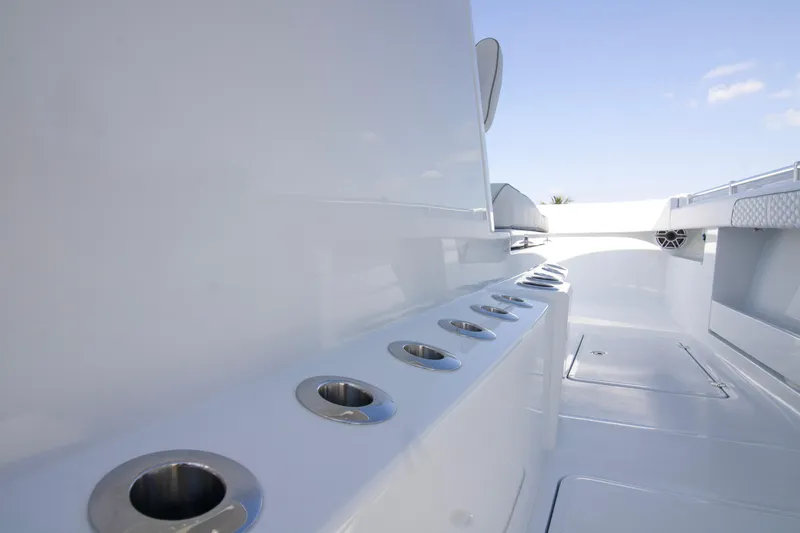 Slide: The Image of 2026 Invincible 36 Catamaran with open storage compartment, sleek white design. - 4