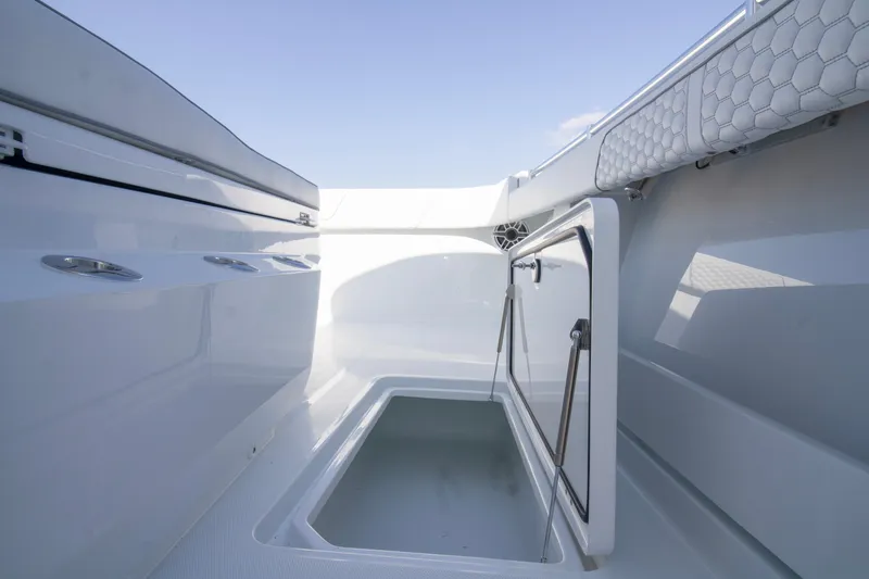 Slide: The Image of Open storage compartment on 2026 Invincible 36 Catamaran deck, showcasing sleek design. - 7