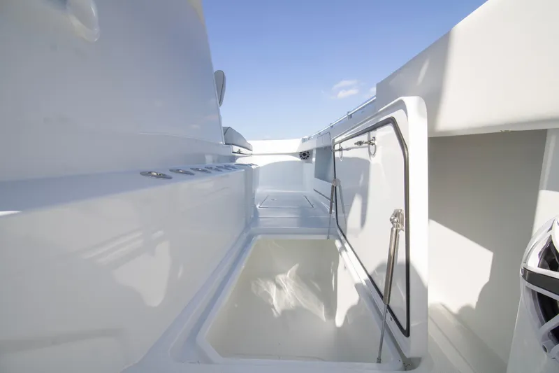 Slide: The Image of 2026 Invincible 36 Catamaran deck with open storage compartment, showcasing sleek design. - 8