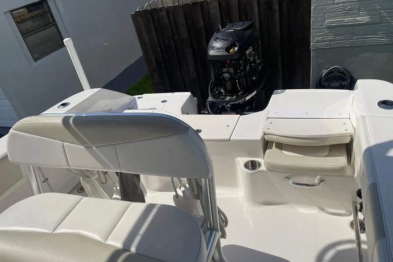 Slide: The Image of 2016 Robalo R200 Center Console boat interior with seating and engine view. - 3