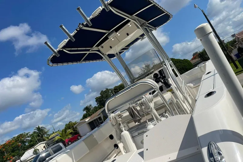 Slide: The Image of 2016 Robalo R200 Center Console boat with T-top under blue sky. - 6