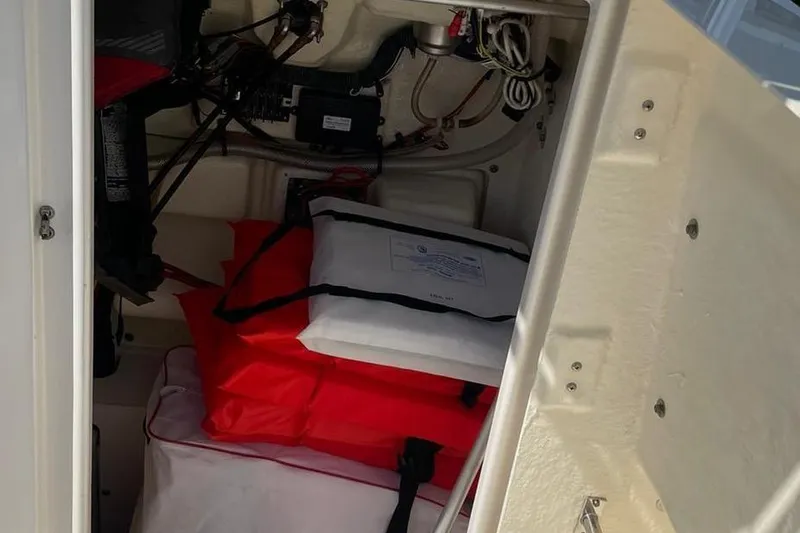 Slide: The Image of Interior storage of 2016 Robalo R200 Center Console boat with equipment and wiring. - 8