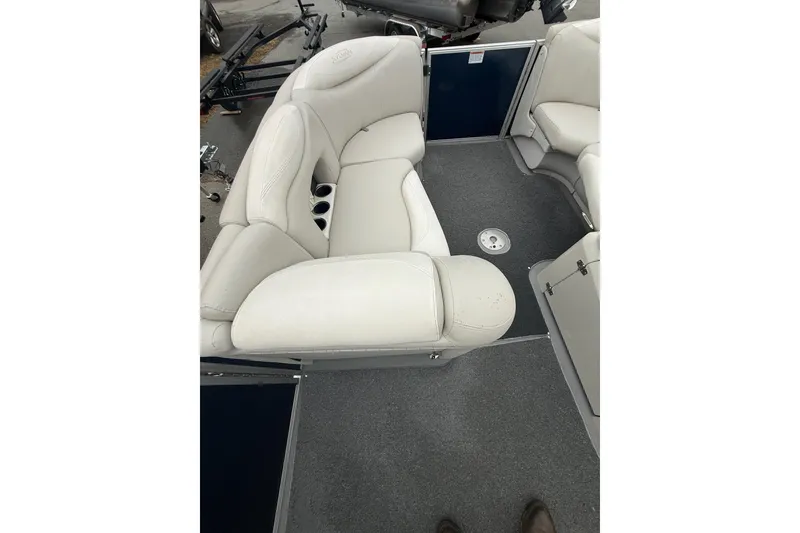 Slide: The Image of 2016 Sylvan Mirage Cruise 8522 LZ LE boat interior with plush seating and cup holders. - 10
