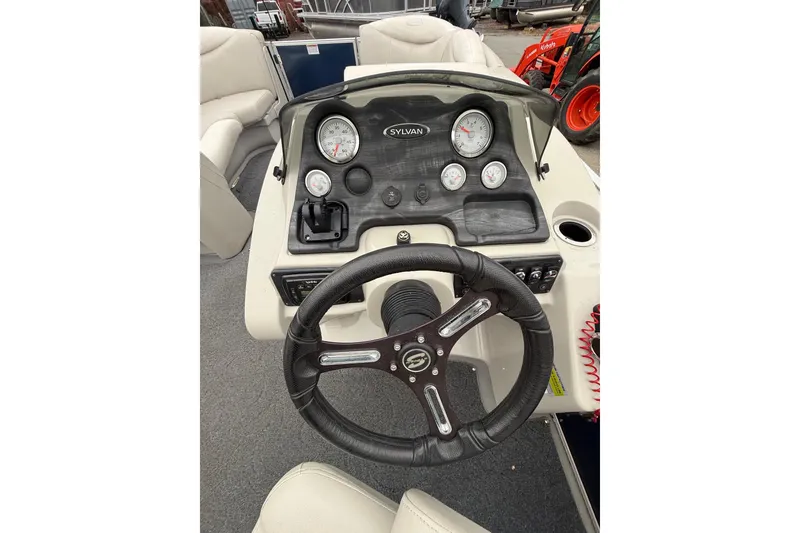 Slide: The Image of 2016 Sylvan Mirage Cruise 8522 LZ LE boat dashboard with steering wheel and gauges. - 13
