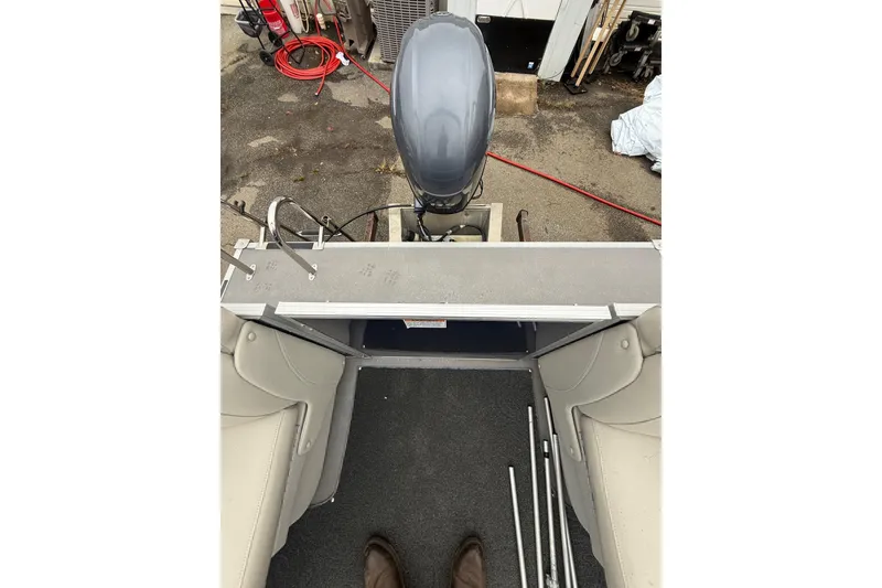 Slide: The Image of 2016 Sylvan Mirage Cruise 8522 LZ LE boat interior with motor and seating. - 18