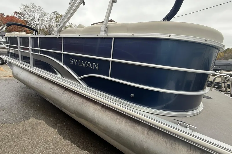 Slide: The Image of 2016 Sylvan Mirage Cruise 8522 LZ LE pontoon boat, blue exterior, docked outdoors. - 2