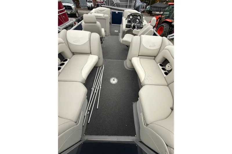 Slide: The Image of 2016 Sylvan Mirage Cruise 8522 LZ LE pontoon boat interior with plush seating and steering console. - 5