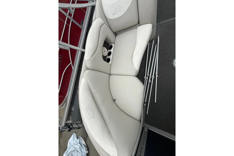 Slide: The Image of White seating on 2016 Sylvan Mirage Cruise 8522 LZ LE boat with metal rods nearby. - 7
