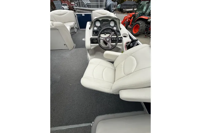 Slide: The Image of 2016 Sylvan Mirage Cruise 8522 LZ LE boat interior with steering console and seating. - 8