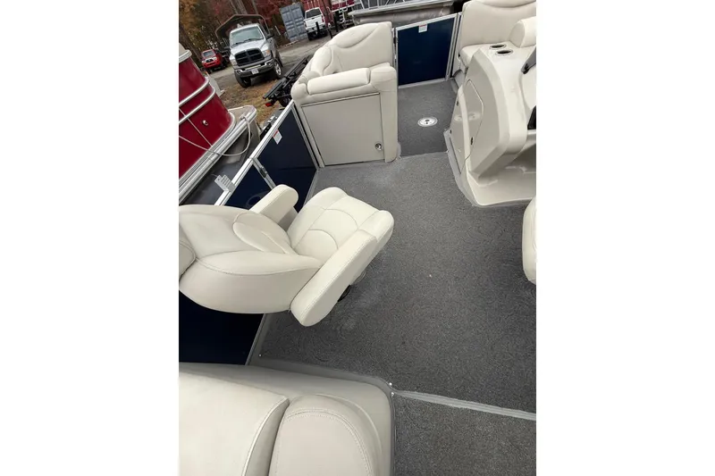 Slide: The Image of 2016 Sylvan Mirage Cruise 8522 LZ LE interior with plush seating and carpeted flooring. - 9