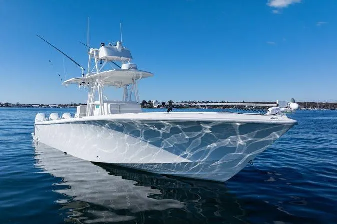 The Image of 2016 SeaVee 390Z boat on calm water under a clear blue sky. - 0