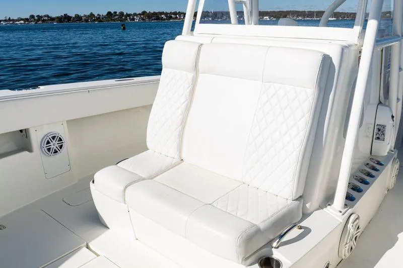 Slide: The Image of 2016 SeaVee 390Z boat with white cushioned seating, on a calm blue sea. - 22