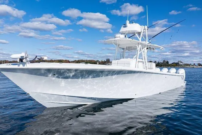 Slide: The Image of 2016 SeaVee 390Z boat on calm water under a blue sky with clouds. - 3