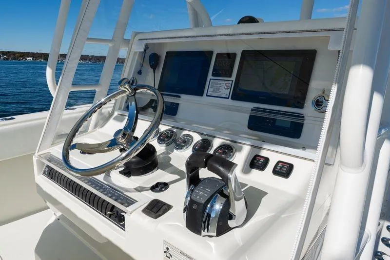 Slide: The Image of 2016 SeaVee 390Z boat dashboard with steering wheel and navigation controls. - 30
