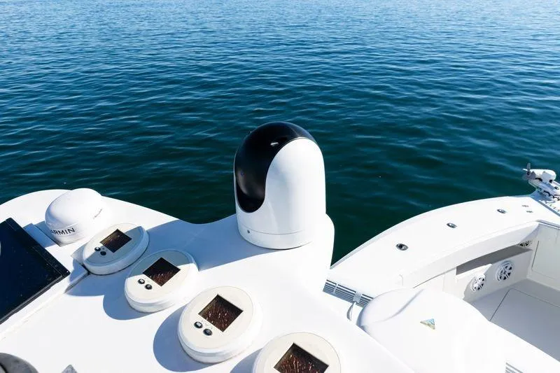 Slide: The Image of 2016 SeaVee 390Z boat dashboard with navigation equipment on calm blue water. - 49