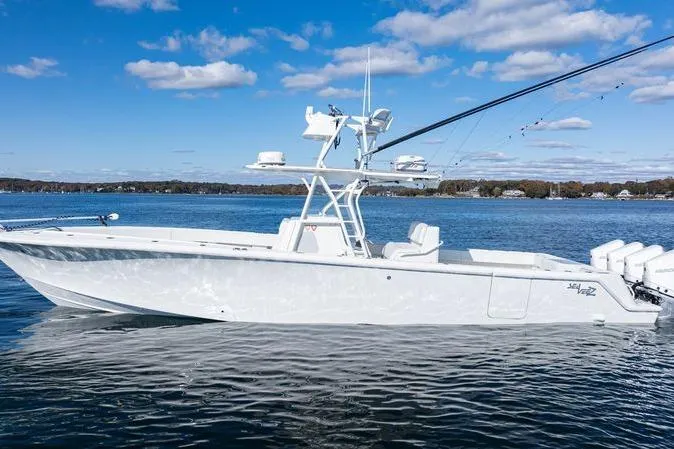 Slide: The Image of 2016 SeaVee 390Z boat on calm water under a clear blue sky. - 5