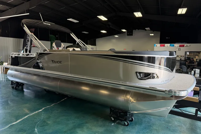 The Image of 2026 Tahoe Pontoon LTZ Entertainer boat displayed indoors, showcasing sleek design and modern features. - 0