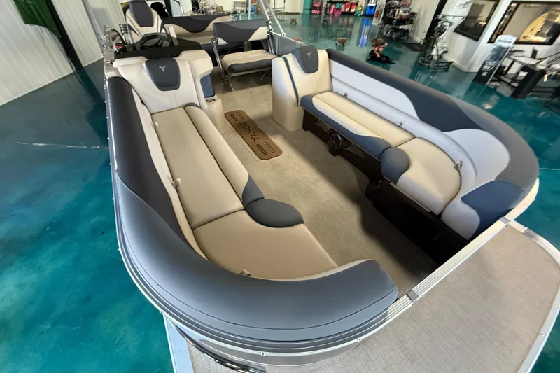 Slide: The Image of 2026 Tahoe Pontoon LTZ Entertainer with luxurious seating in showroom. - 10