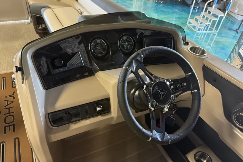 Slide: The Image of 2026 Tahoe Pontoon LTZ Entertainer dashboard with steering wheel and control panel. - 11