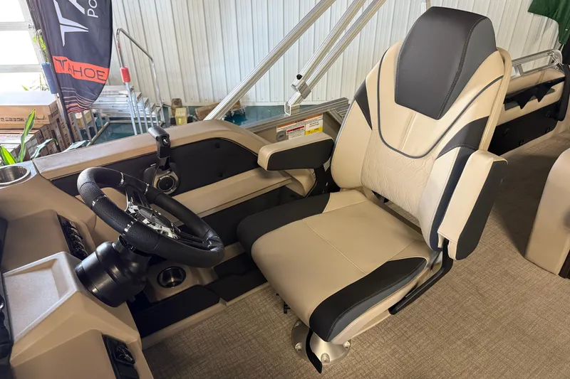 Slide: The Image of Captain's chair and steering wheel of 2026 Tahoe Pontoon LTZ Entertainer boat. - 5
