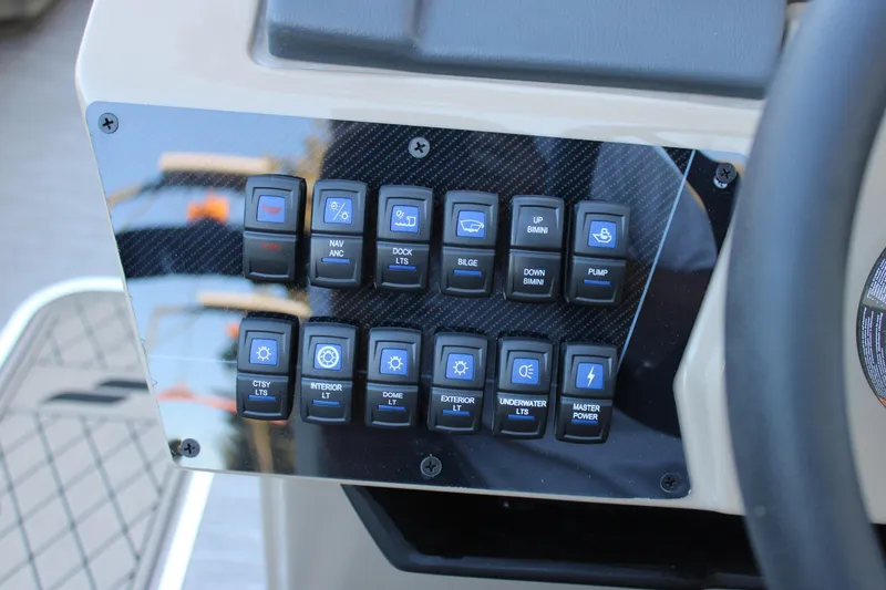 Slide: The Image of Control panel of 2026 Starcraft SLS 3 boat with various function switches. - 16