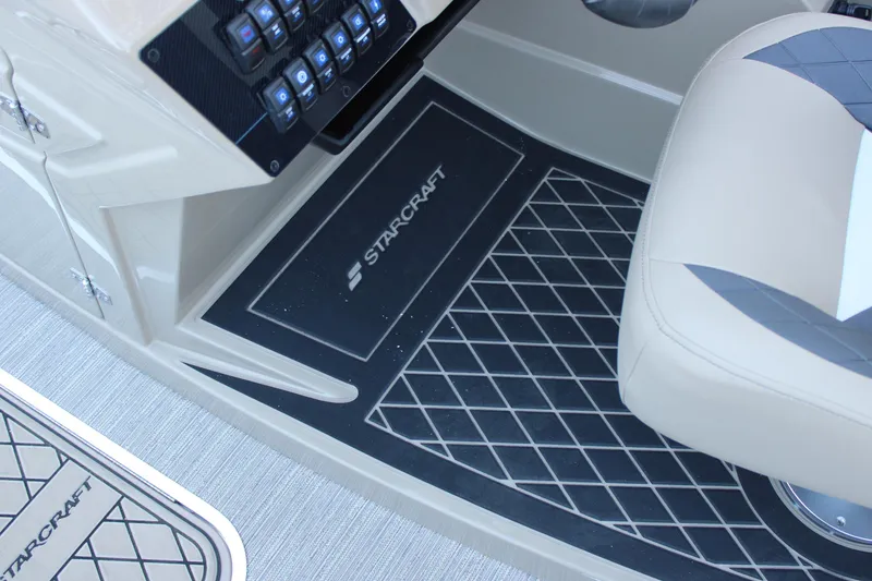 Slide: The Image of Interior of 2026 Starcraft SLS 3 boat with beige seating and control panel. - 19