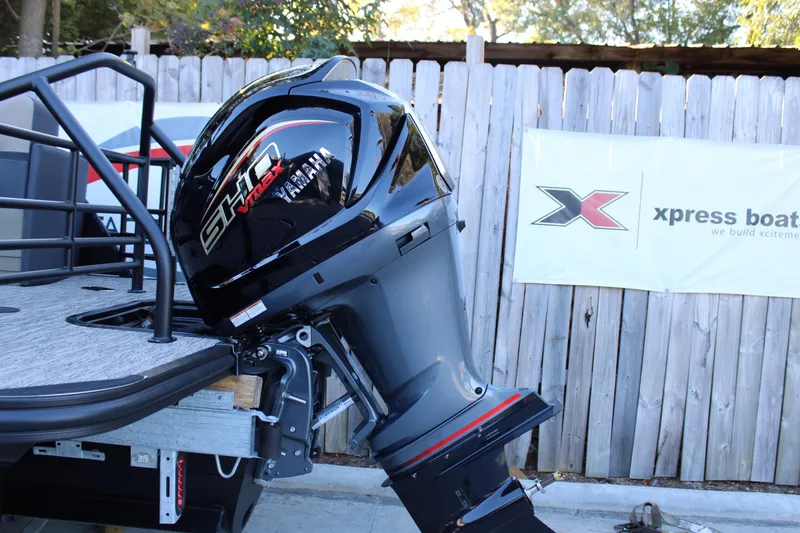 Slide: The Image of 2026 Starcraft SLS 3 boat with Yamaha outboard motor, parked near wooden fence. - 5