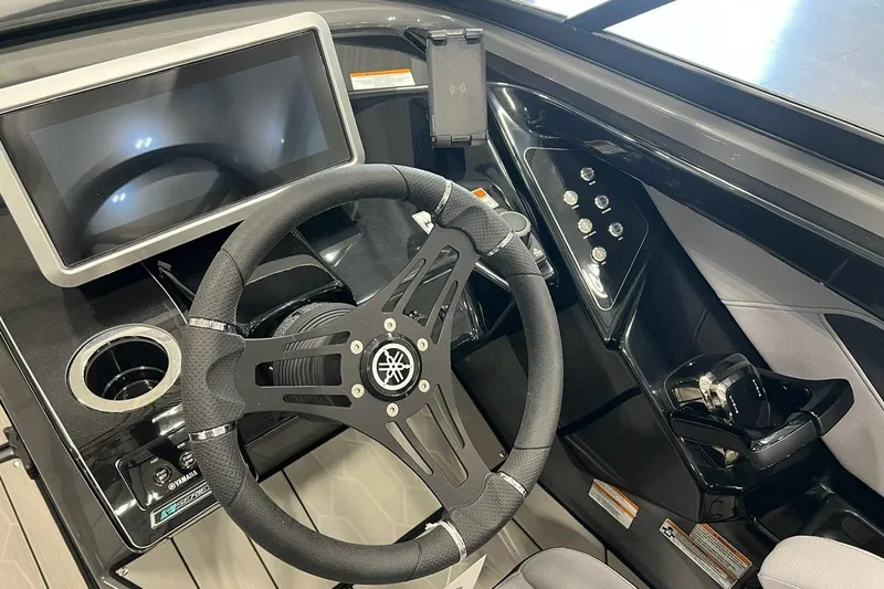 Slide: The Image of 2025 Yamaha Boats 255XE dashboard with steering wheel, touchscreen, and control panel. - 5