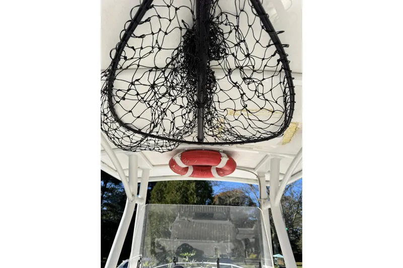 Slide: The Image of 2004 Regulator 24 Forward Seating boat with fishing net and life preserver. - 17