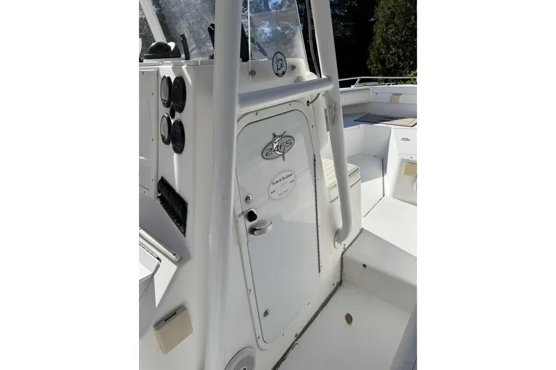 Slide: The Image of 2004 Regulator 24 Forward Seating boat interior with steering wheel and seating area. - 18
