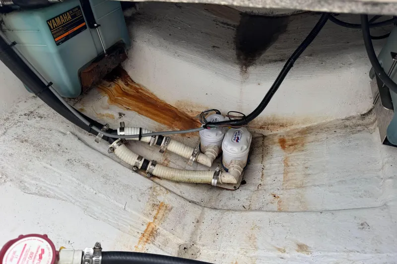 Slide: The Image of Bilge area of 2004 Regulator 24 Forward Seating boat with Yamaha oil tank and hoses. - 24
