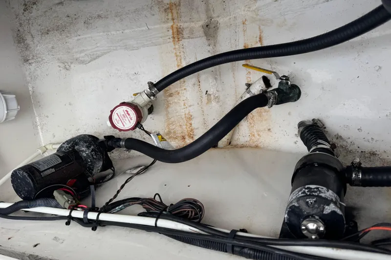 Slide: The Image of 2004 Regulator 24 Forward Seating boat interior wiring and plumbing components. - 25