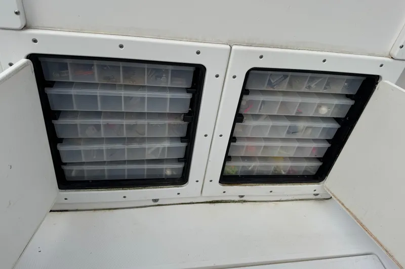 Slide: The Image of Storage compartments with tackle boxes on a 2004 Regulator 24 Forward Seating boat. - 26