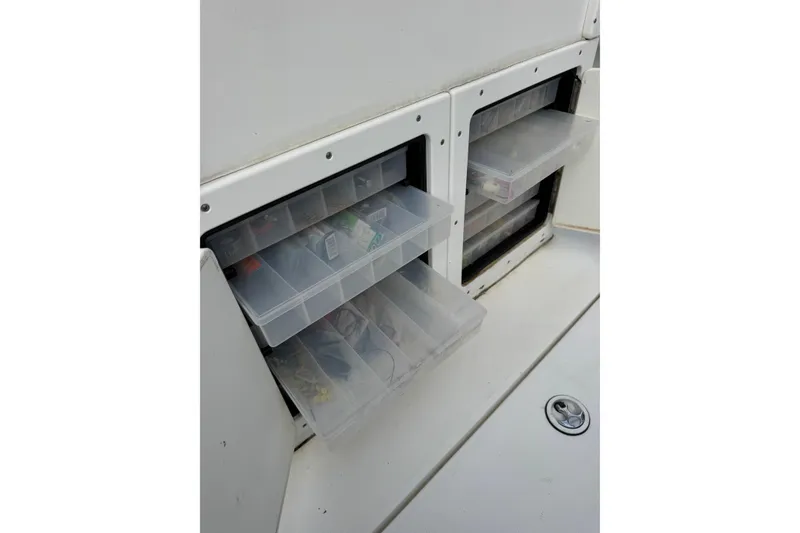 Slide: The Image of Storage compartments with tackle boxes on a 2004 Regulator 24 Forward Seating boat. - 27