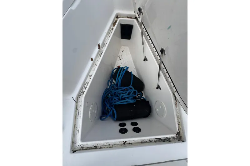 Slide: The Image of Storage compartment of 2004 Regulator 24 Forward Seating boat with blue rope and fenders. - 30