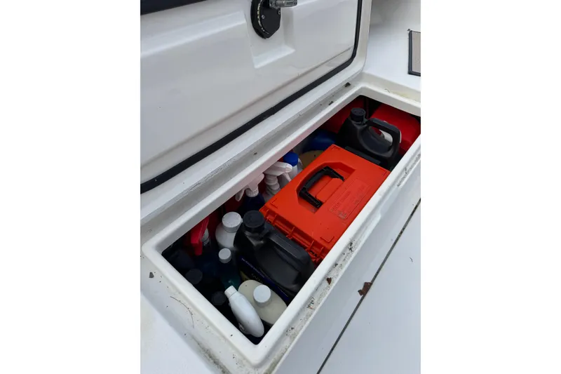 Slide: The Image of Storage compartment on a 2004 Regulator 24 Forward Seating boat, filled with supplies. - 31
