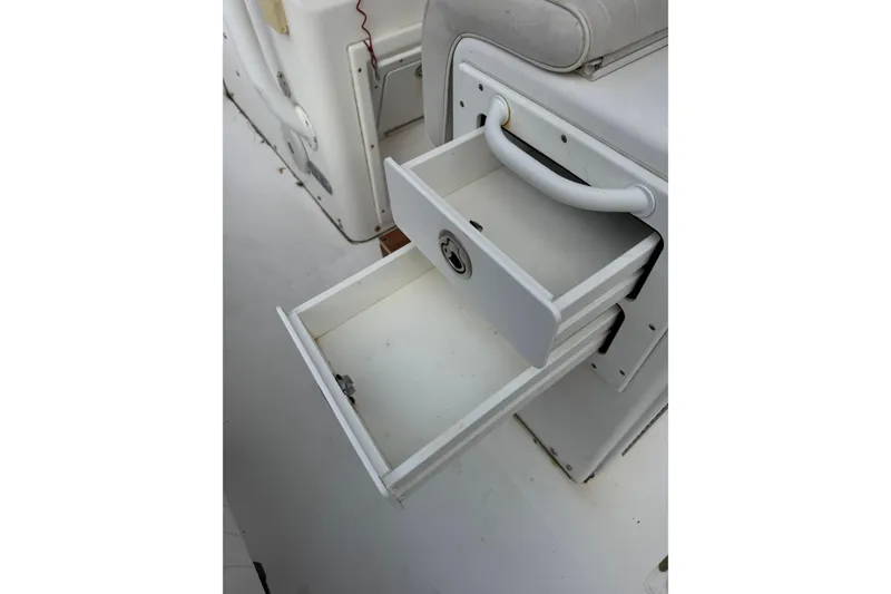Slide: The Image of Open storage drawer on 2004 Regulator 24 Forward Seating boat interior. - 32