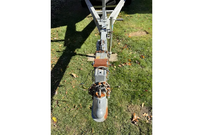 Slide: The Image of Trailer hitch of a 2004 Regulator 24 Forward Seating boat on grass. - 4