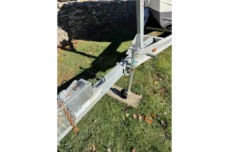 Slide: The Image of Trailer hitch of a 2004 Regulator 24 Forward Seating boat on grass. - 5